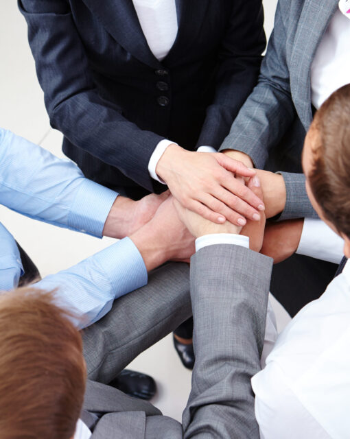 Image of business people hands on top of each other